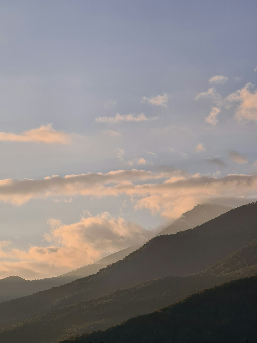 a landscape with hills and clouds