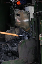 a metal object with a wooden handle