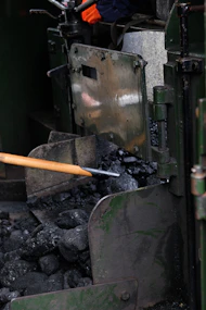 a metal object with a wooden handle