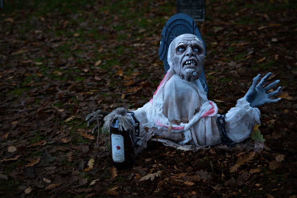 a statue of a person with a bottle of water in a yard