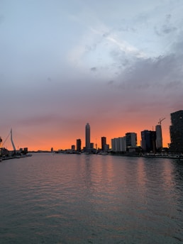 Vibrant view of Brisbane's city skyline at sunset with the Story Bridge lit up.