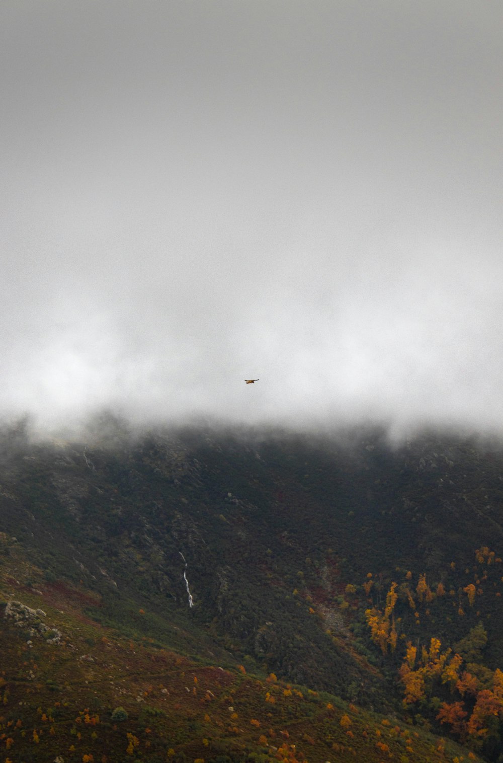 a helicopter flying over a mountain