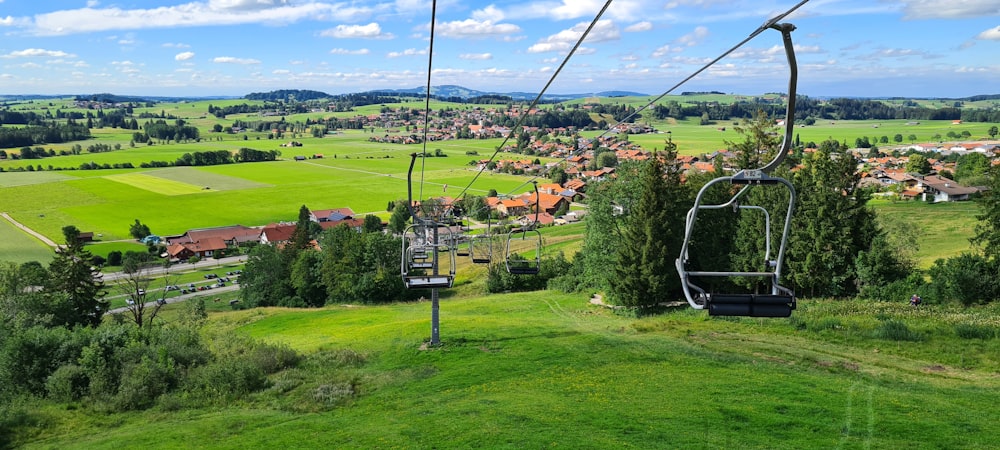 a cable car above a green field