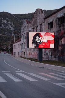 a road with a building and a sign on it