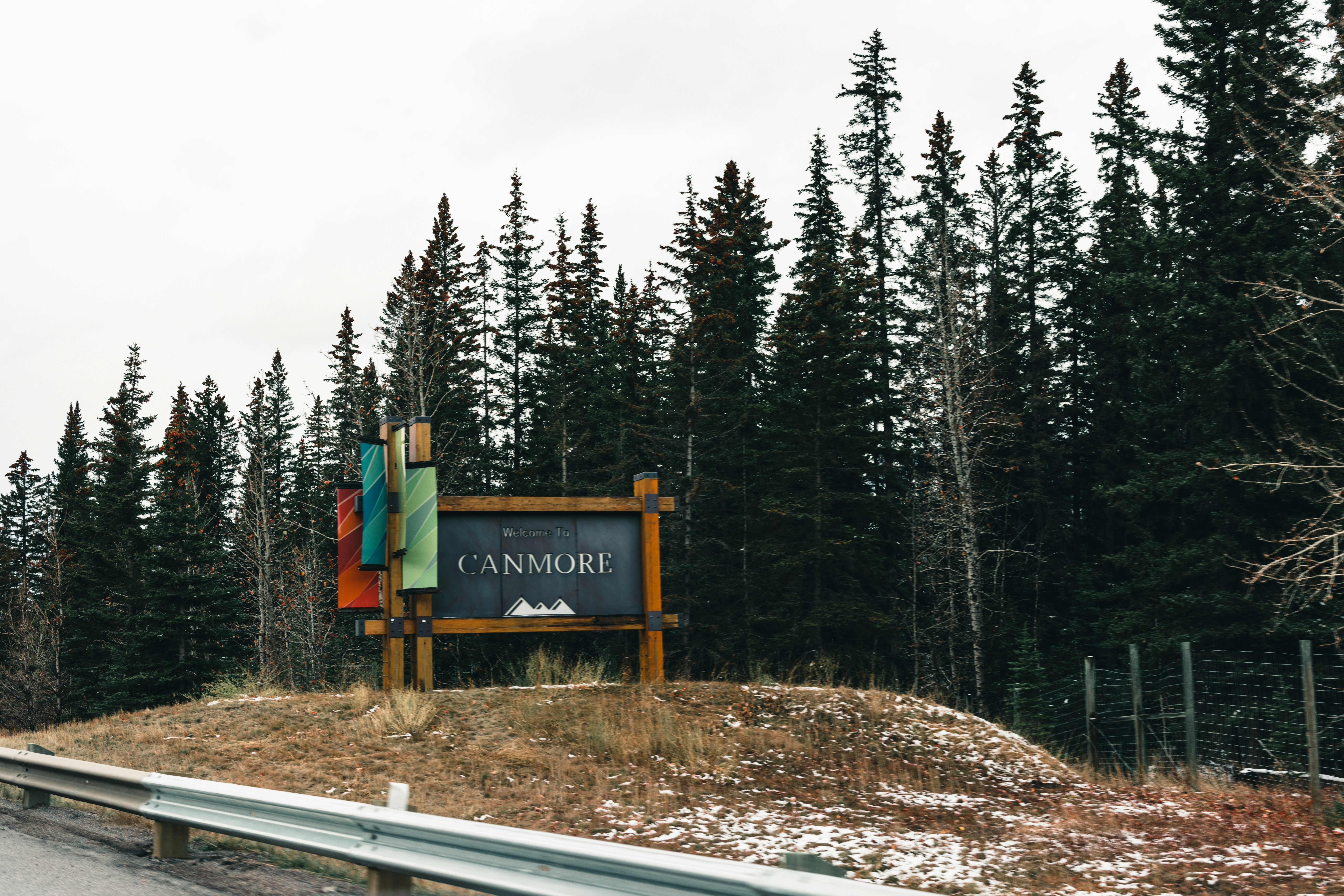 A sign in front of a forest