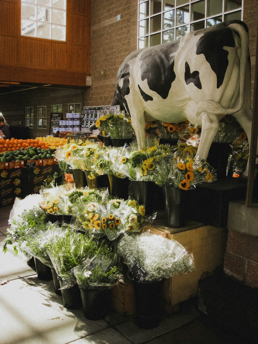 a cow statue in a flower shop