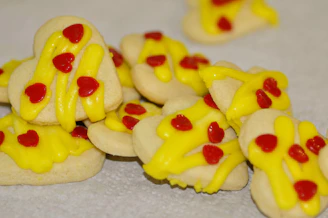 A joyful group of volunteers packaging cookies in a bright community center.