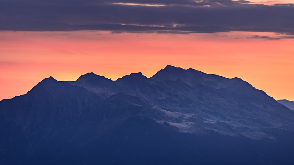 a mountain range with clouds