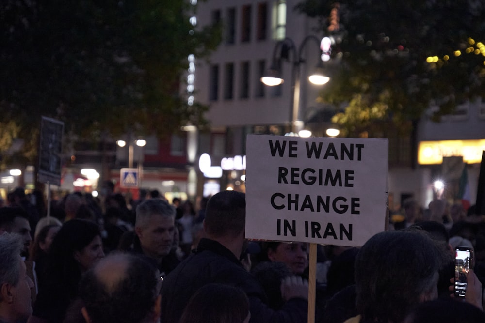 a crowd of people holding signs