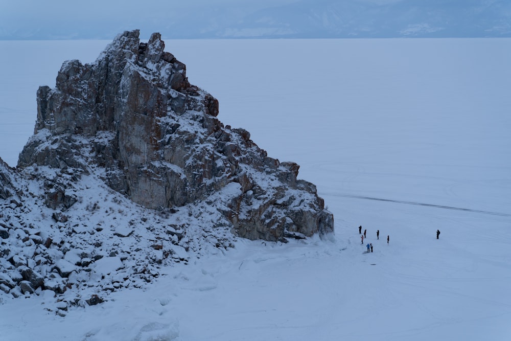 a group of people walking on a snowy mountain