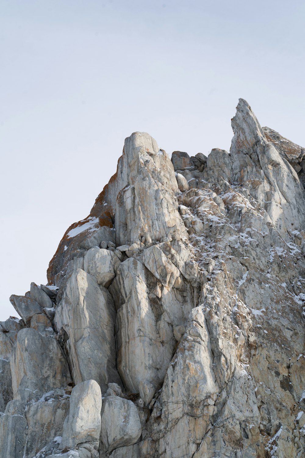 a rocky mountain with a large stack of rocks on top