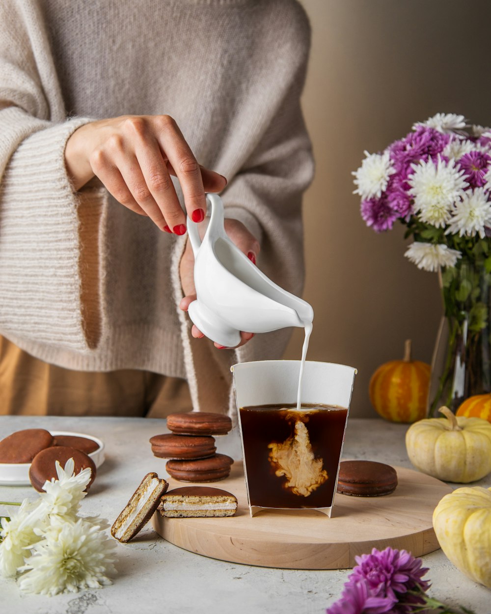 a person pouring a drink into a cup