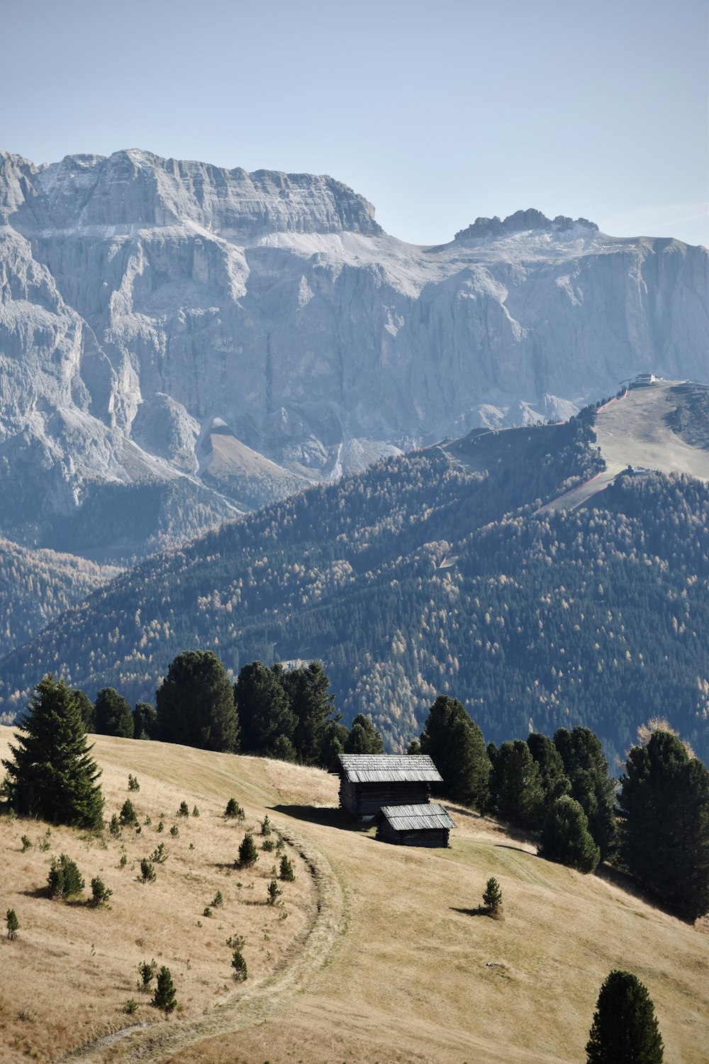 a building in the middle of a valley with mountains in the background