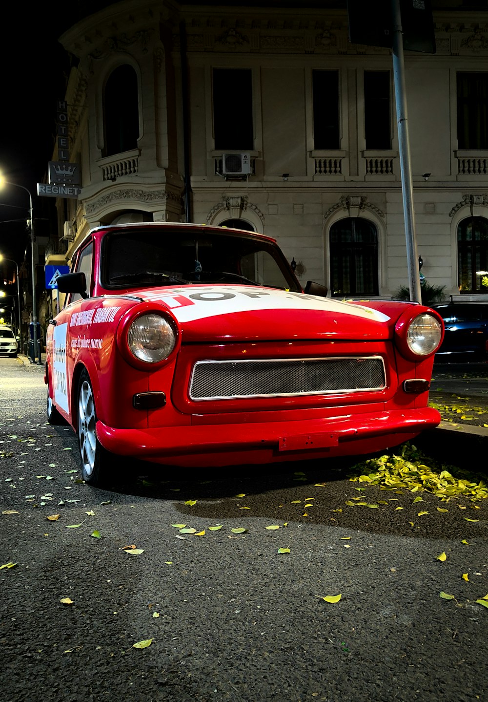 a red car parked on the side of a street