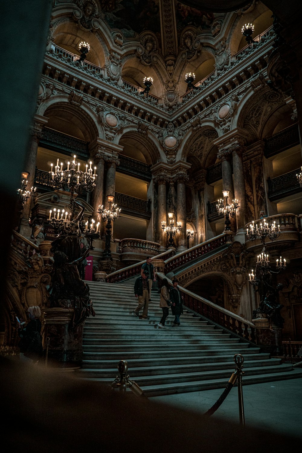 people standing on the stairs of a large ornate building