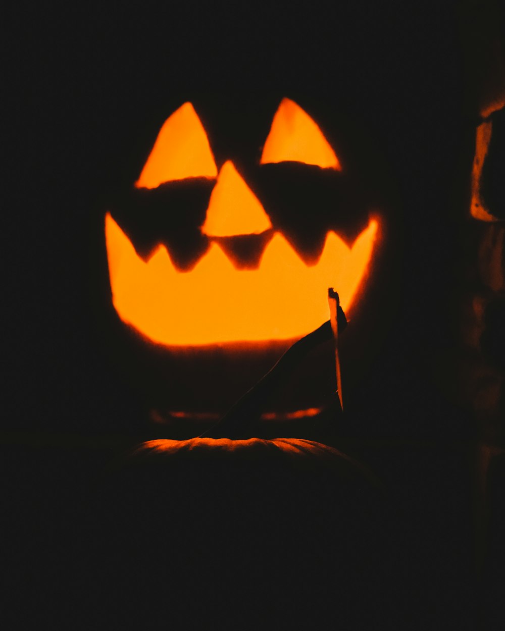 a carved pumpkin with a candle inside