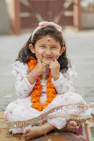 a young girl sitting on the floor