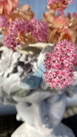 A close-up of a cylindrical vase with flowers.