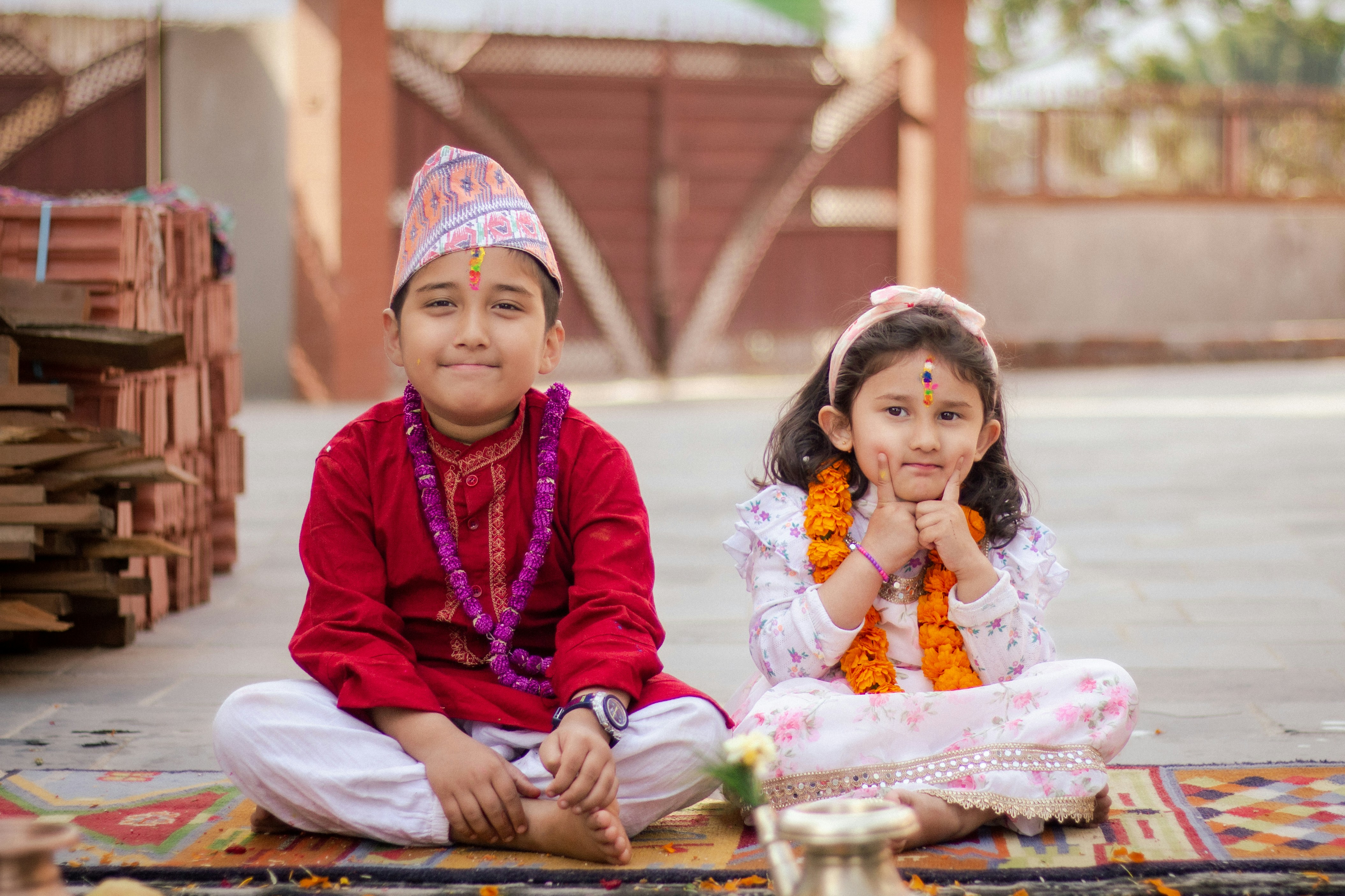 a couple of young girls sitting on the ground