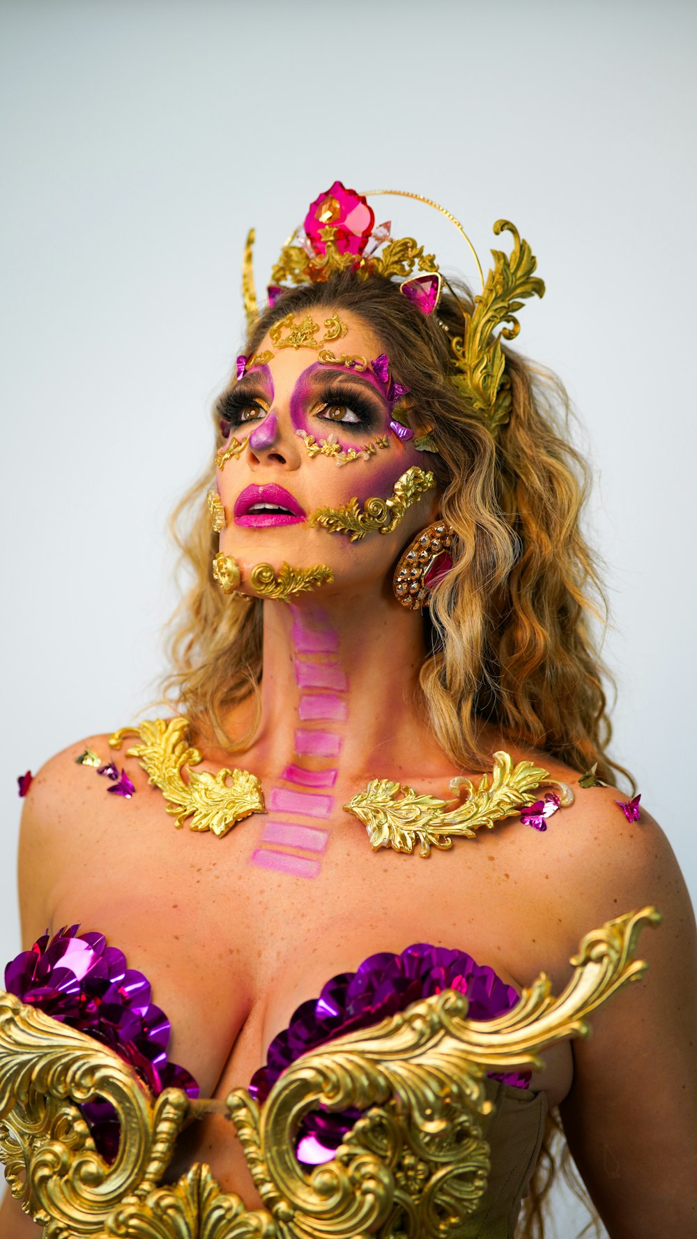 a woman with colorful makeup and a crown