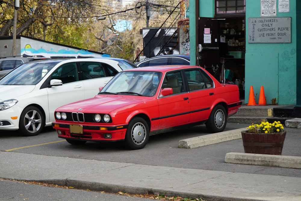 a red car parked on the side of a street