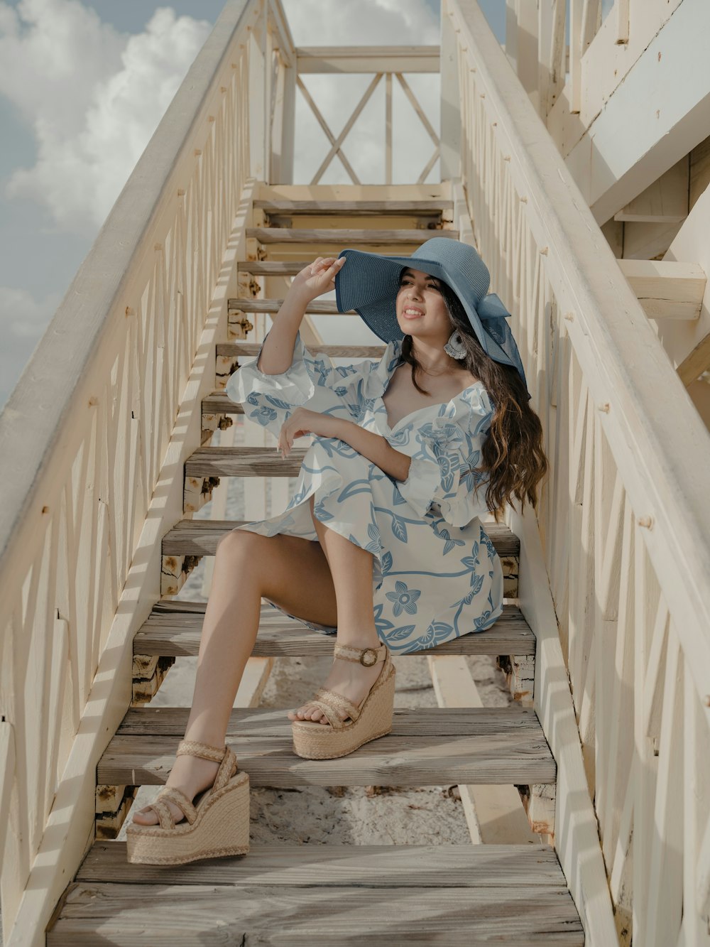 a woman sitting on a wooden staircase