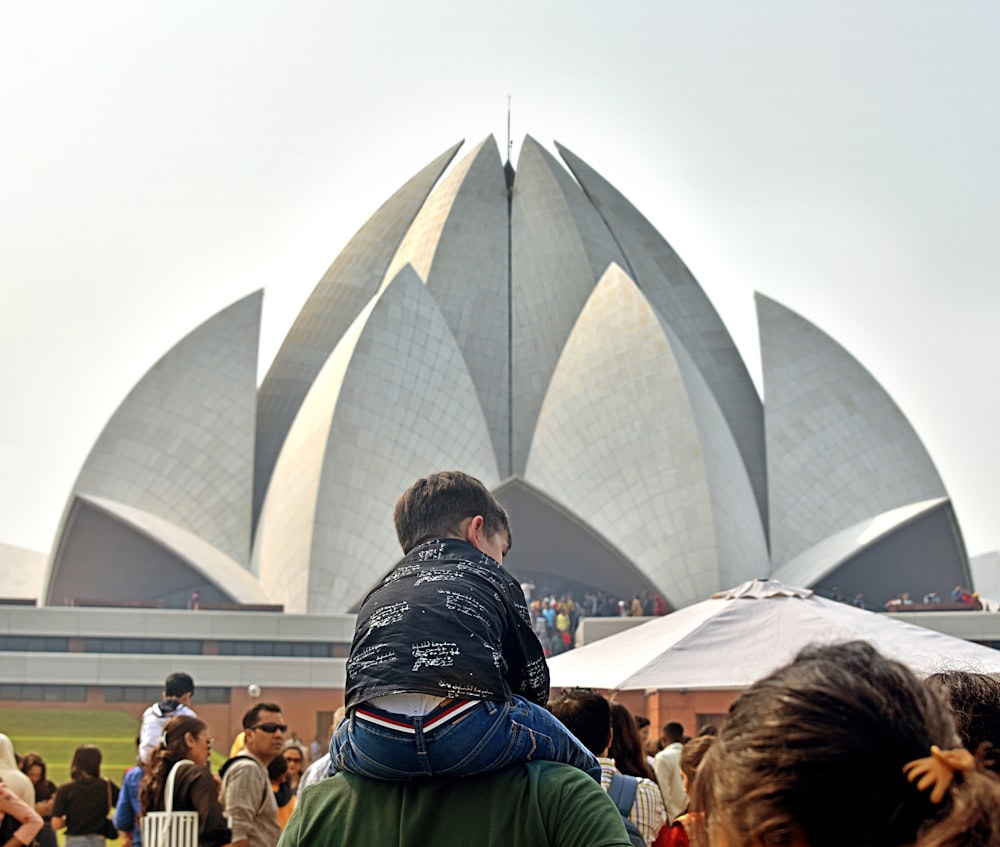 a group of people outside with Lotus Temple in the background