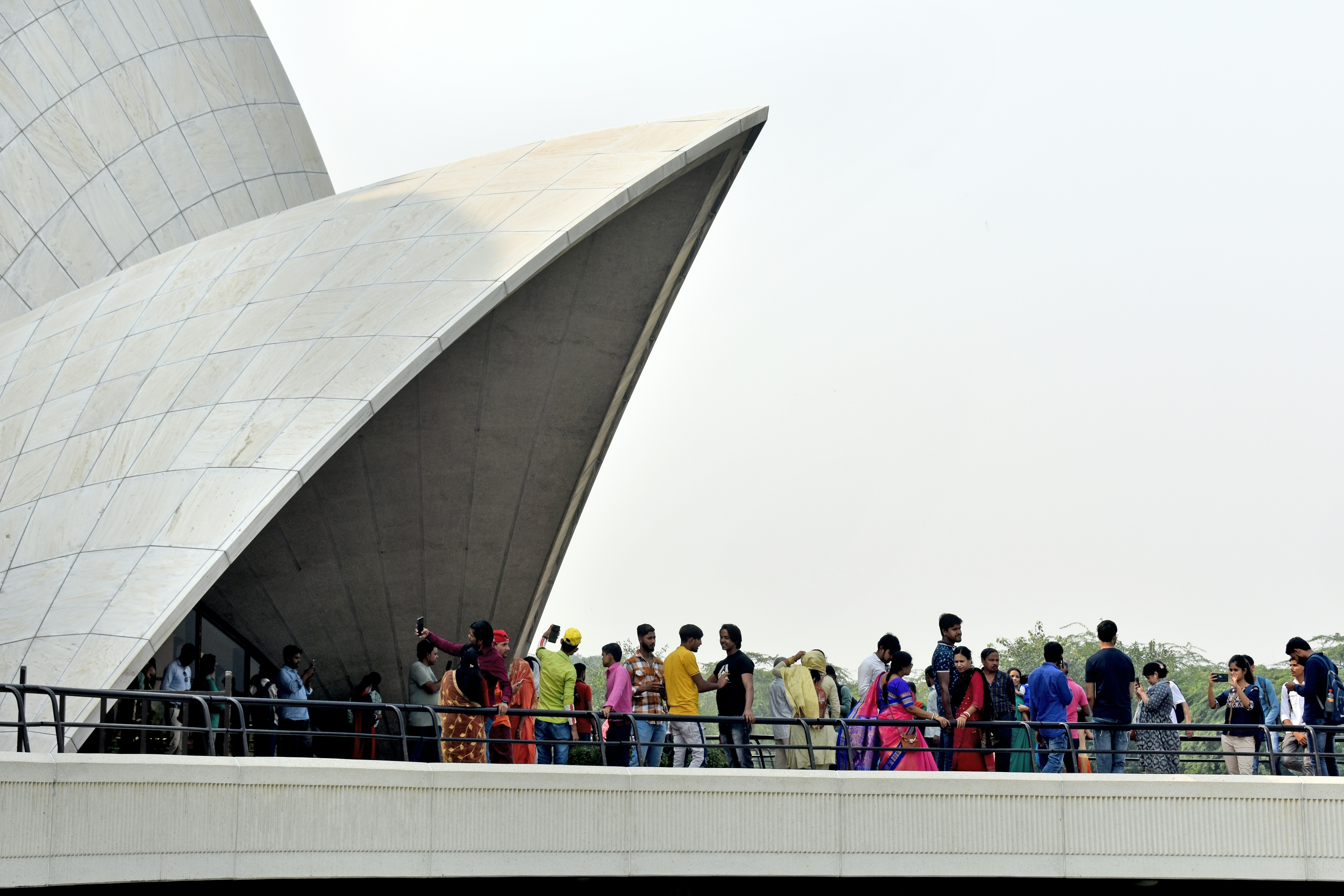 Visitors wait at the upper deck before entering the prayer hall at Lotus Temple, the Bahai House of Worship, New Delhi, India [Photo: October 2022]