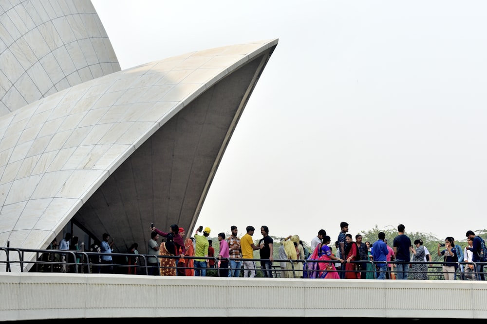 a group of people standing on a bridge