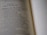 A close-up view of an open book with text discussing the qualities of a wife of noble character. The focus is on a specific passage, while the rest of the text is blurred, creating a depth of field effect.