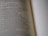 A close-up view of an open book with text discussing the qualities of a wife of noble character. The focus is on a specific passage, while the rest of the text is blurred, creating a depth of field effect.