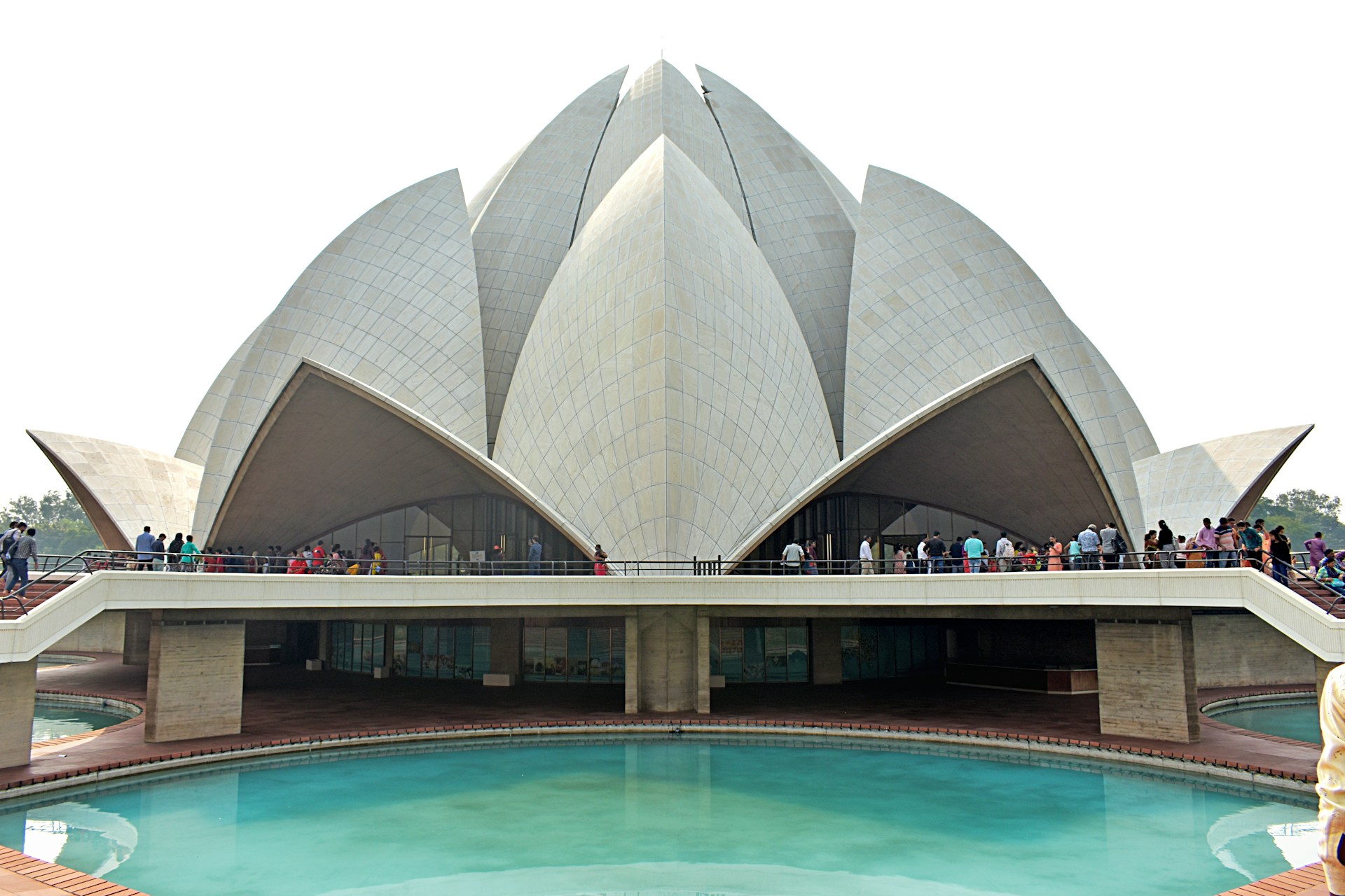 a large building with a pool in front of it with Lotus Temple in the background