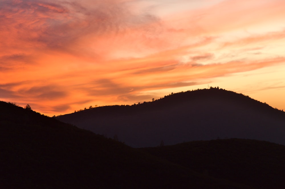 a hill with a sunset in the background