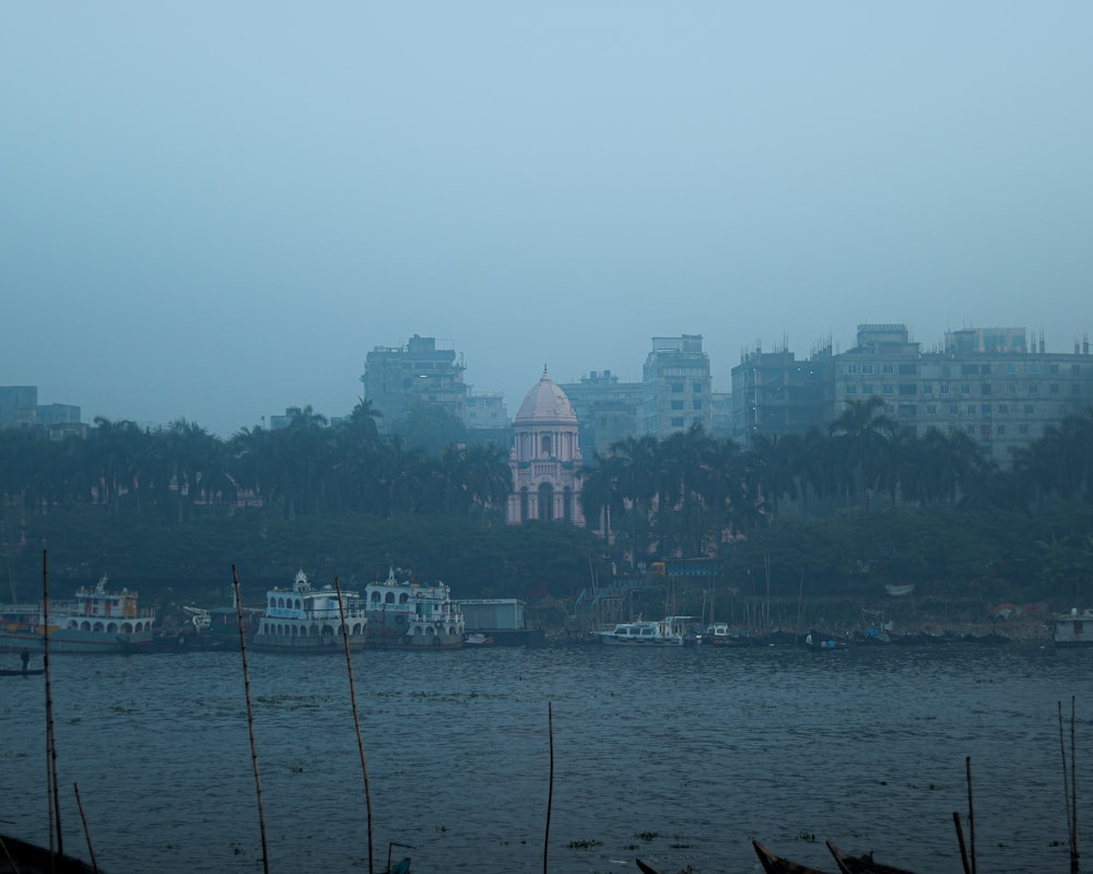 a body of water with boats and buildings in the background