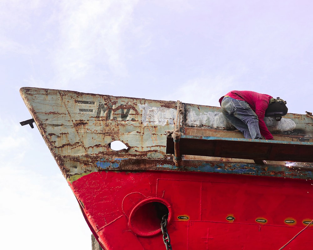 a person climbing on a red train