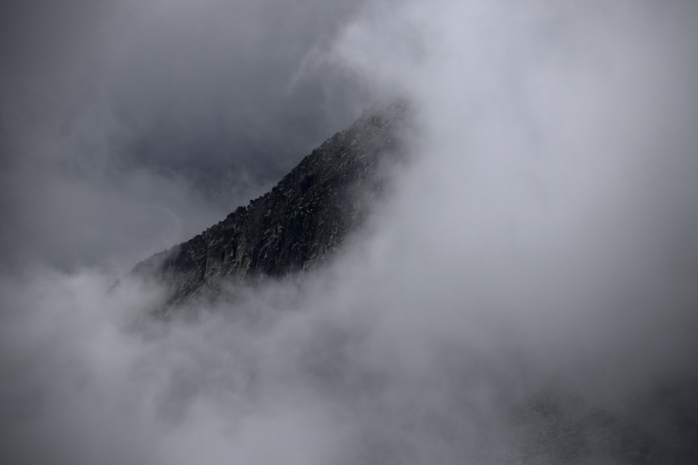 a mountain with clouds around it