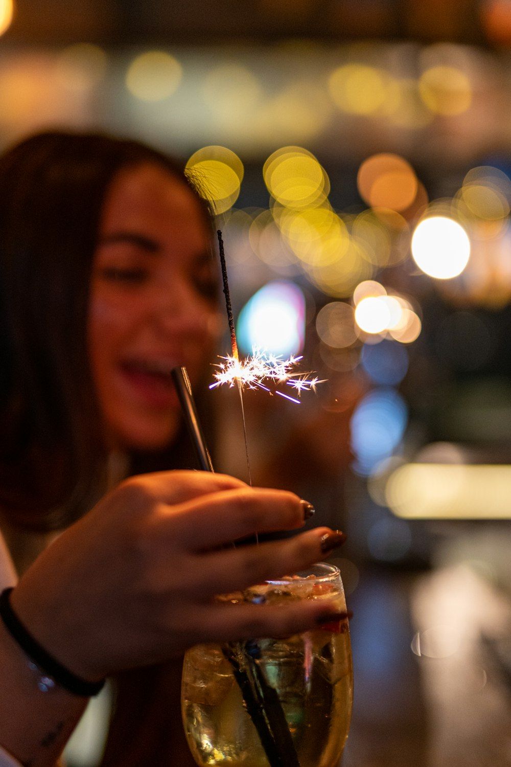 a person holding a glass with a liquid in it