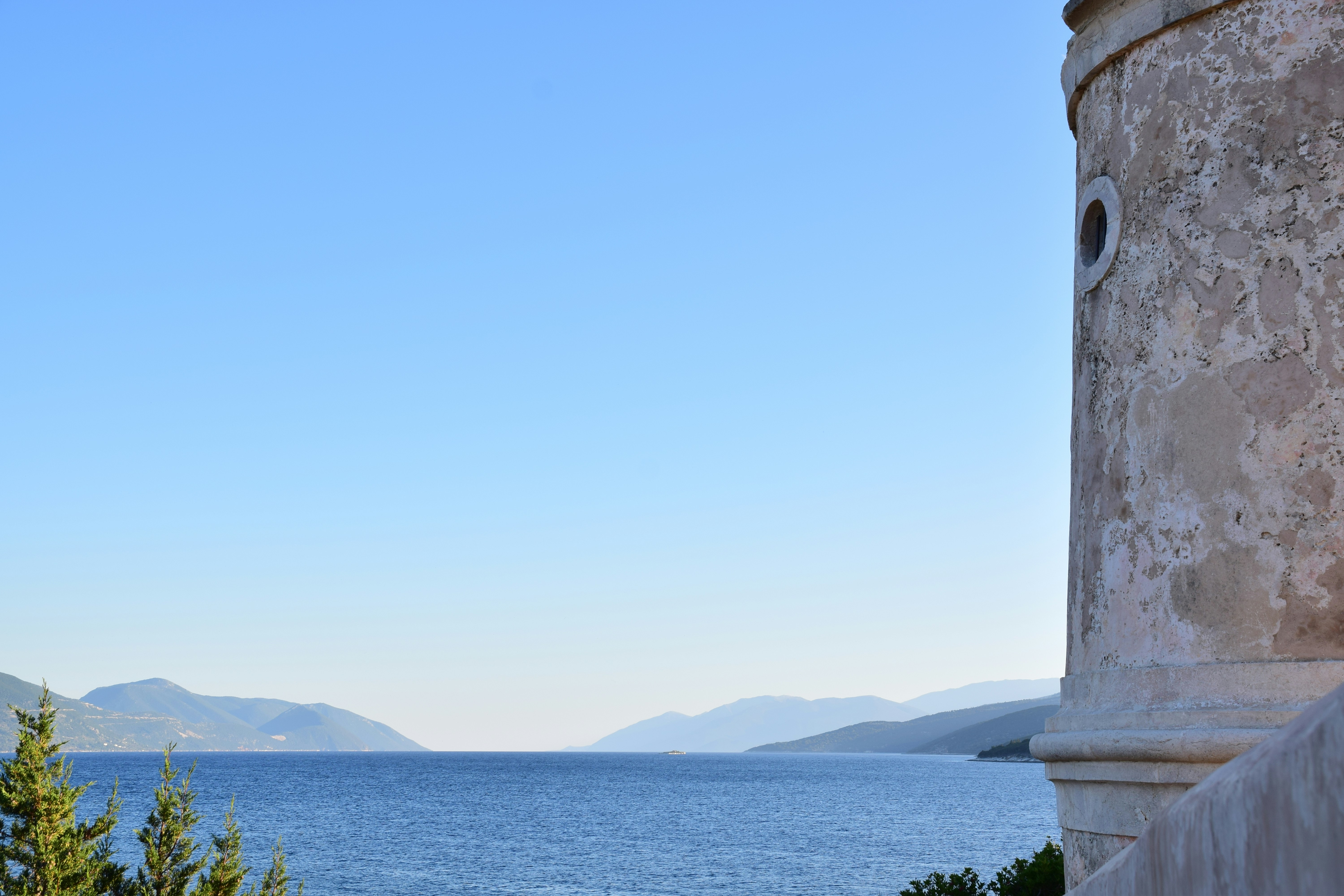 a view of the ocean from a stone building