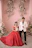 Elegant couple posing with a magazine-style photo booth backdrop in soft pink tones.