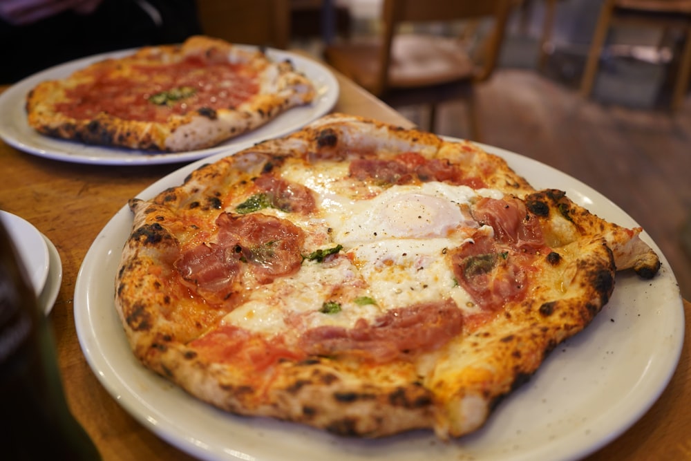 a couple of pizzas on plates