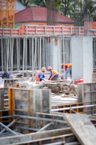 a group of construction workers working on a building