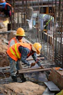 a few men in hardhats working on a construction site