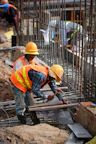 a few men in hardhats working on a construction site