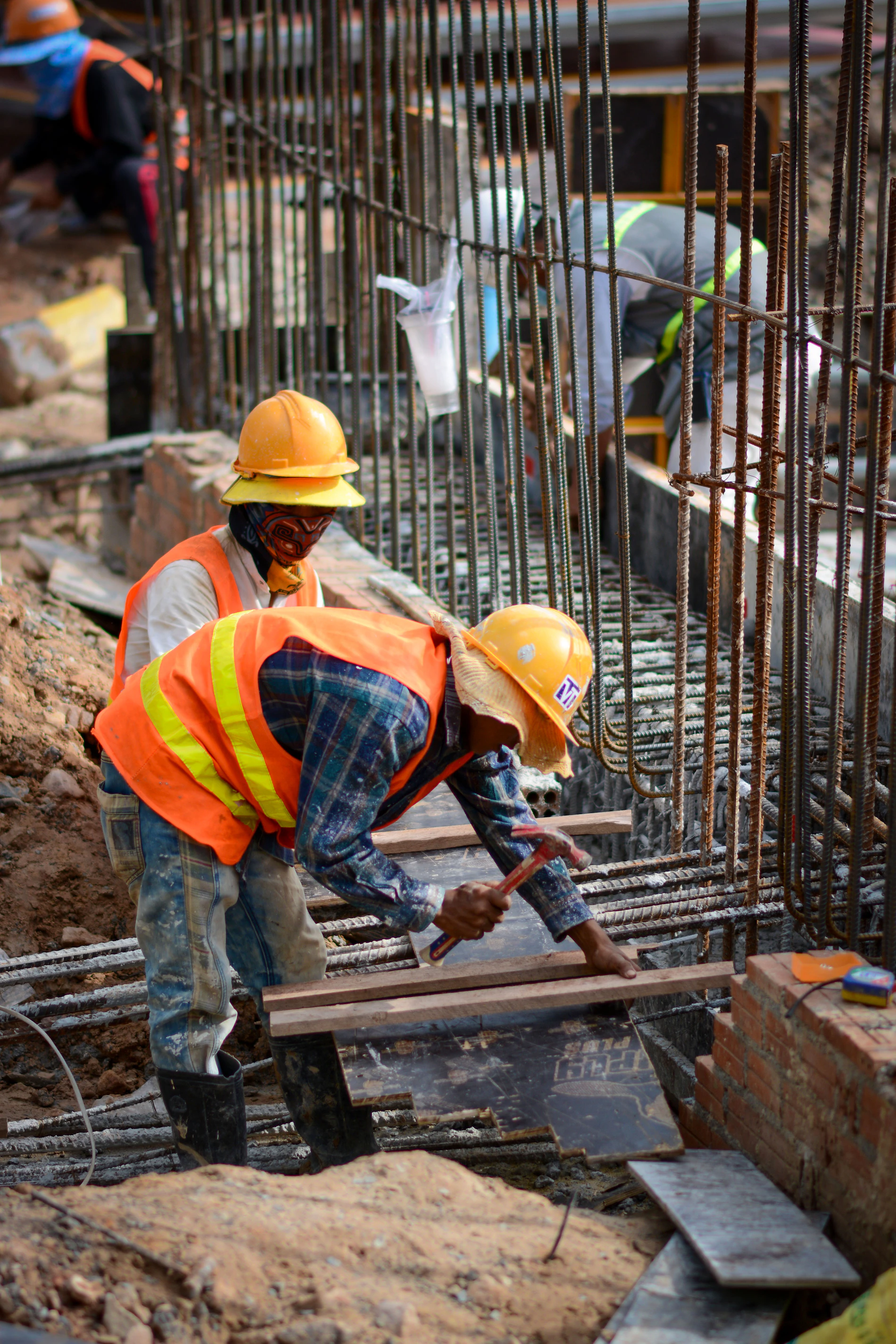 Group of CSCS-carded workers in hard hats on a construction site