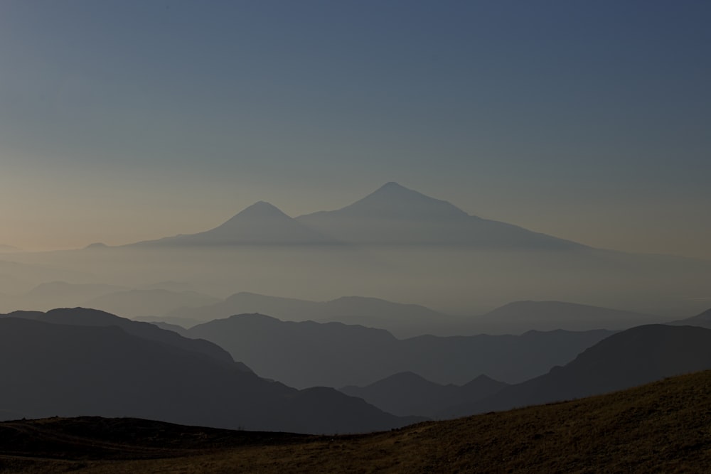 a mountain range with fog