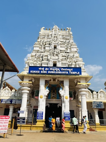 A serene temple entrance with traditional Indian architectural elements under a clear sky.
