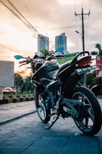 A sleek electric motorcycle parked on a city street during daytime.