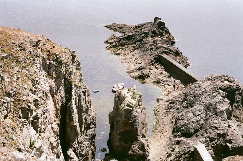 a rocky cliff with boats