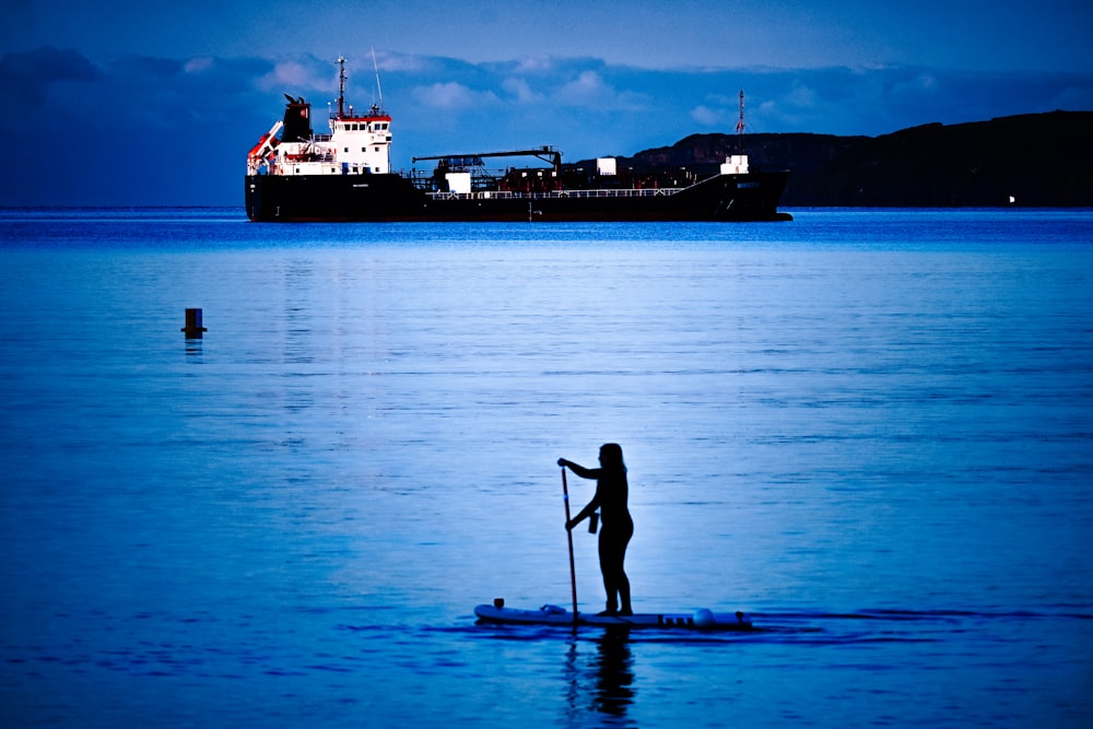 a person paddles a surfboard