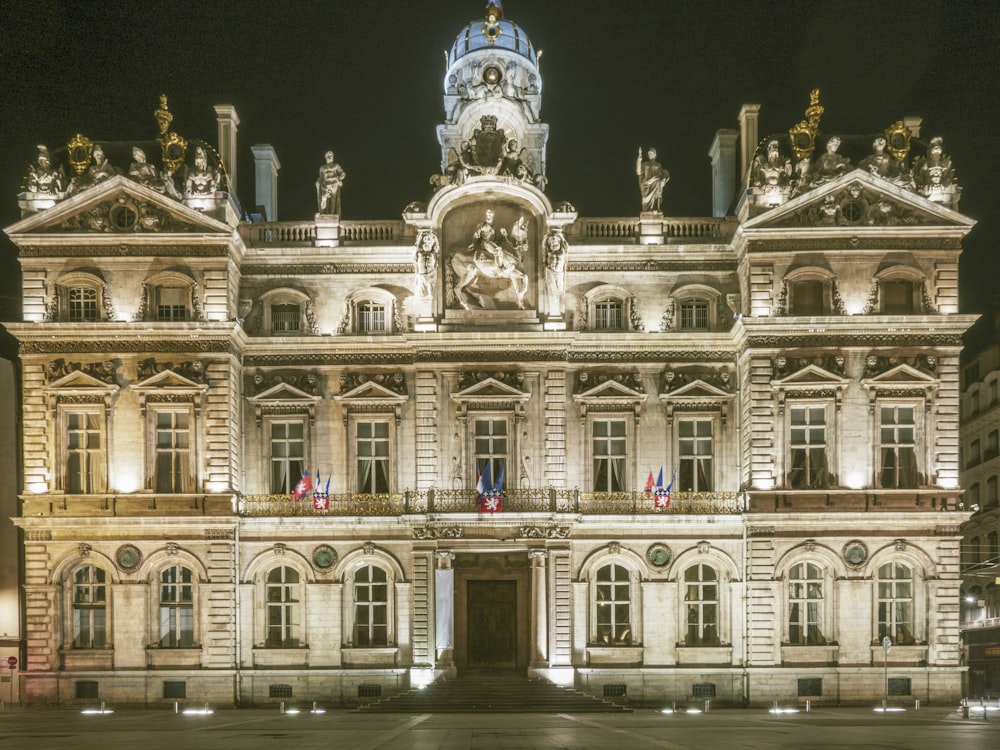 a large building with statues on top with Hôtel de Ville in the background